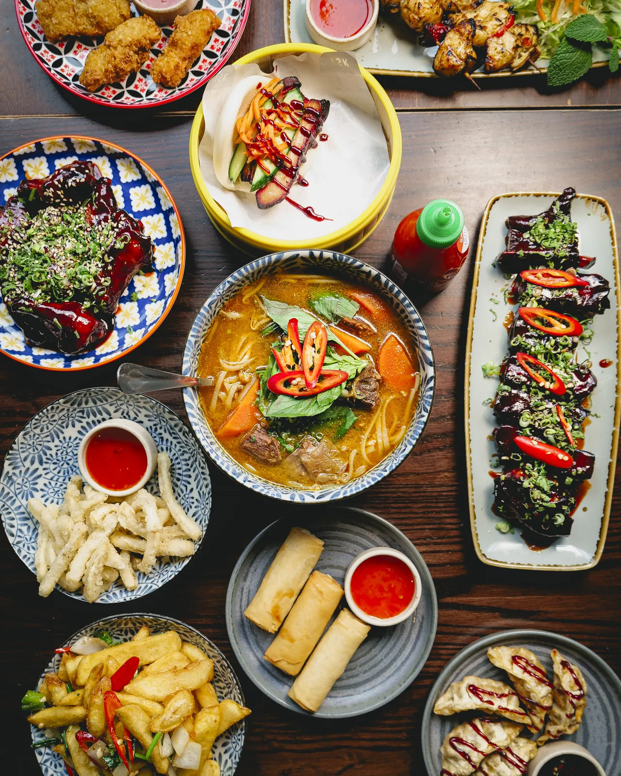 A sharing spread of Vietnamese street food at Vietnamese Street Kitchen Birmingham — bao buns, summer rolls and pho